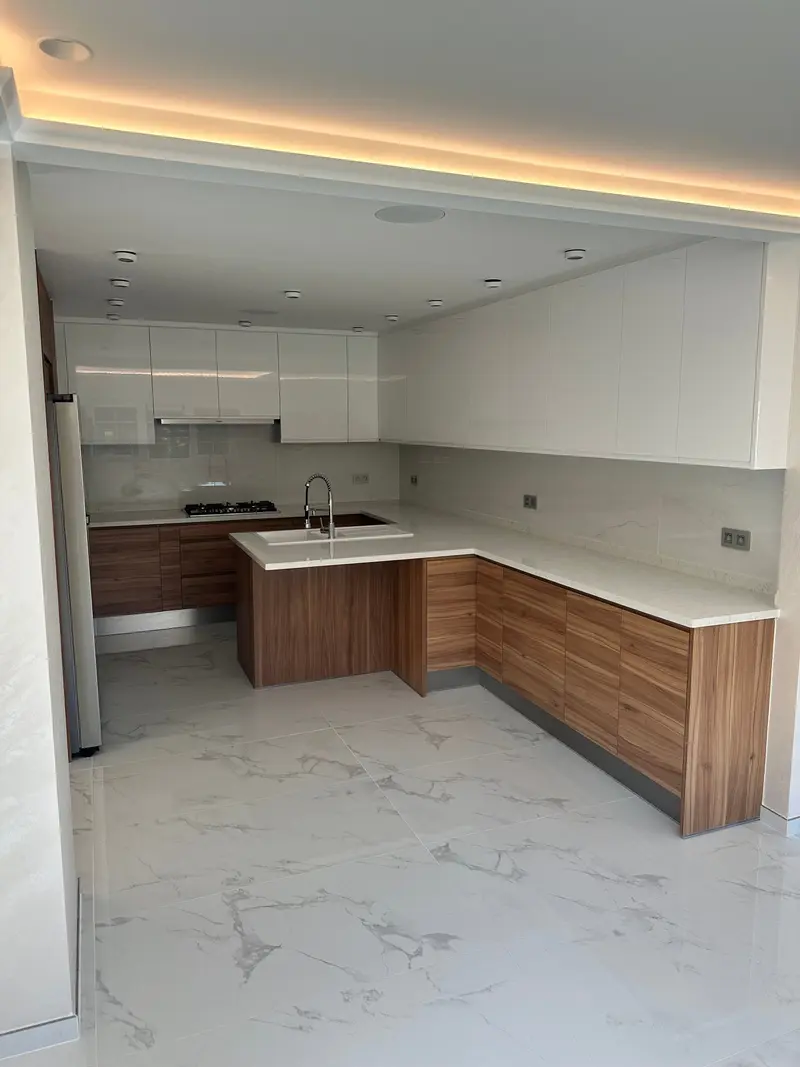 Kitchen with walnut fronts, composite worktop and sink.